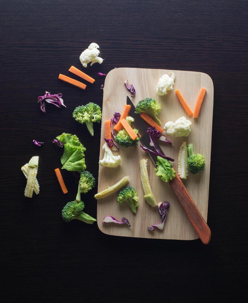 Mixed Vegetables have a carrots, broccoli, cauliflower,  Purple cabbage, lettuce on cutting boards with knife - clean food concept photo