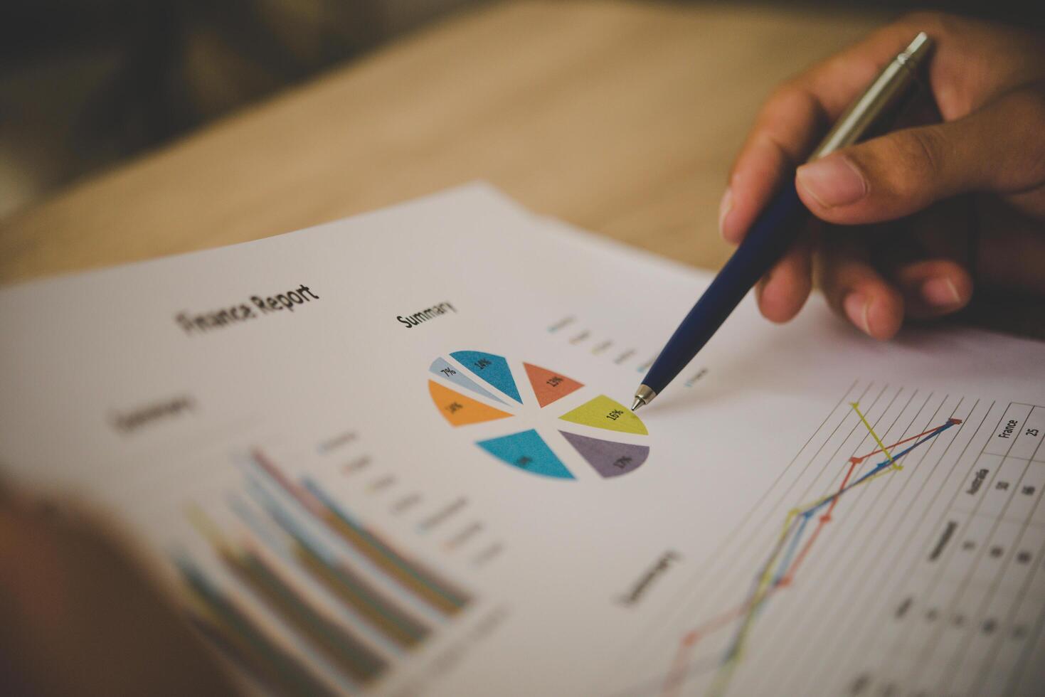 Businessman holding and analyzing investment chart working in office. Business work concept. photo