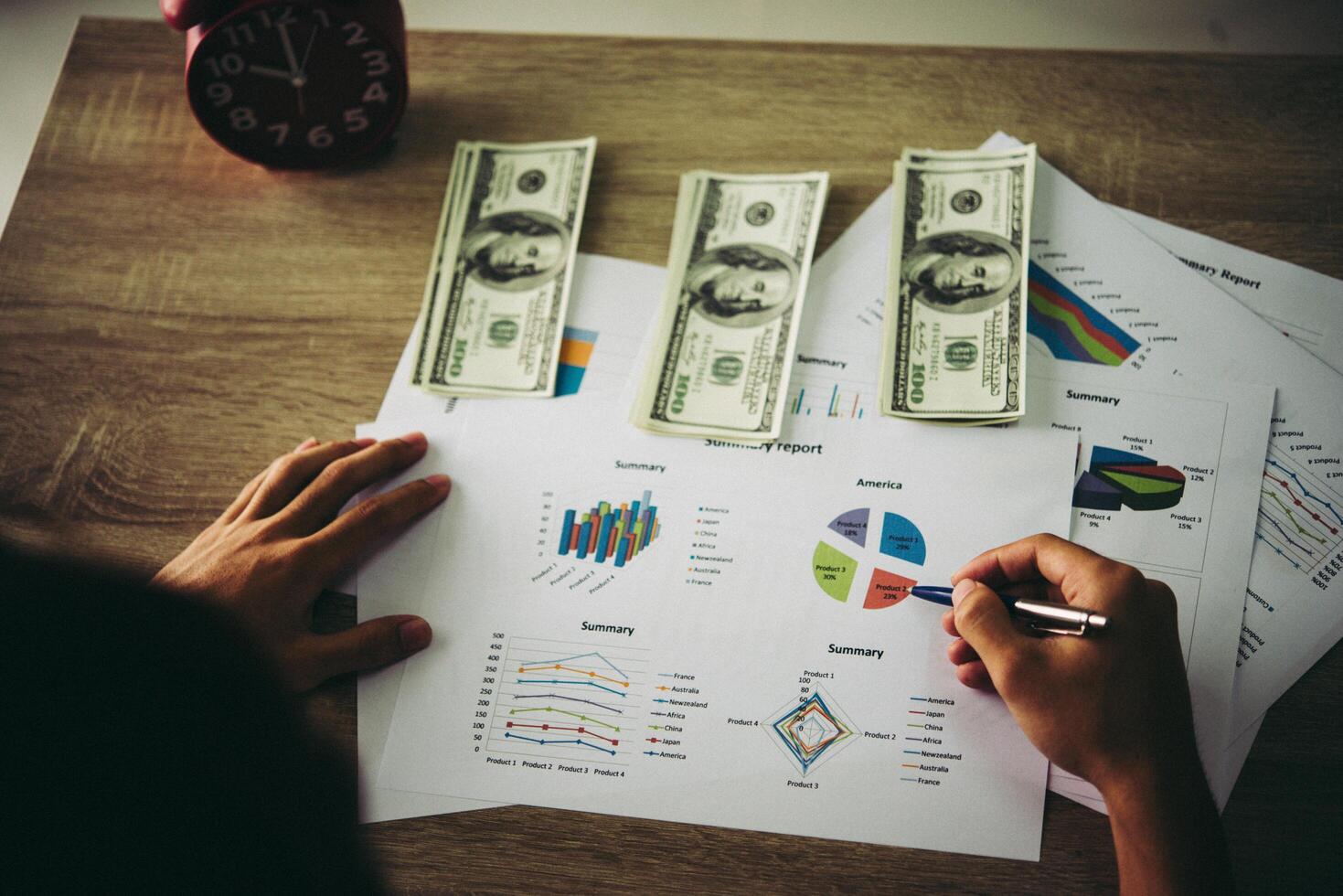 Working place of trader. The table covered by cash notes, keyboard and financial charts. Business financial working. photo