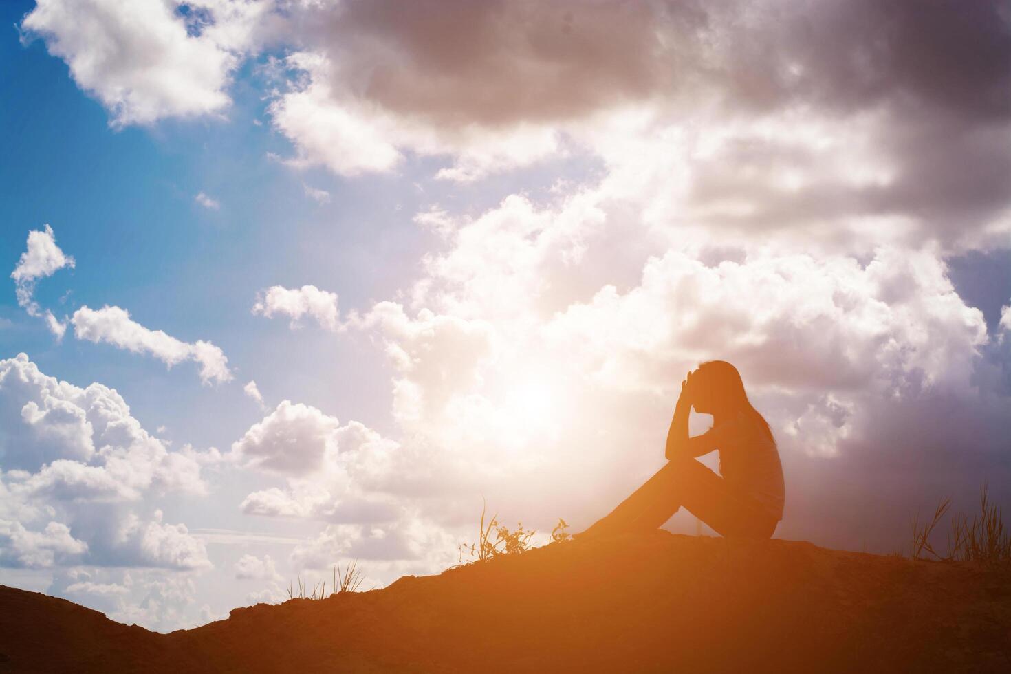 Sad woman sitting alone. photo