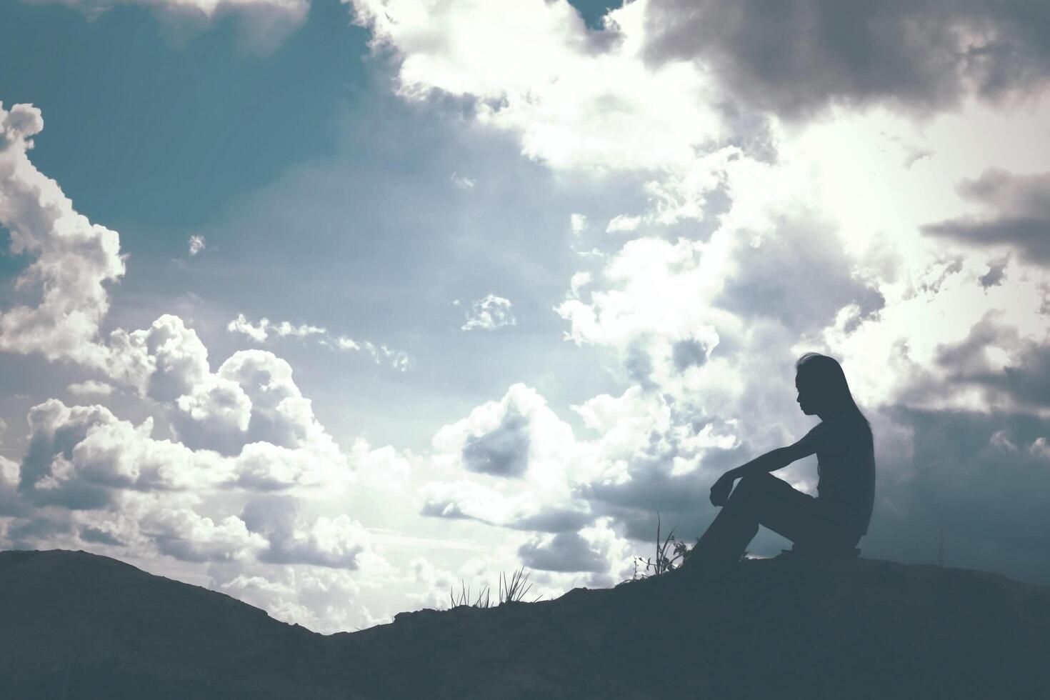 Sad and depressed woman sitting alone photo