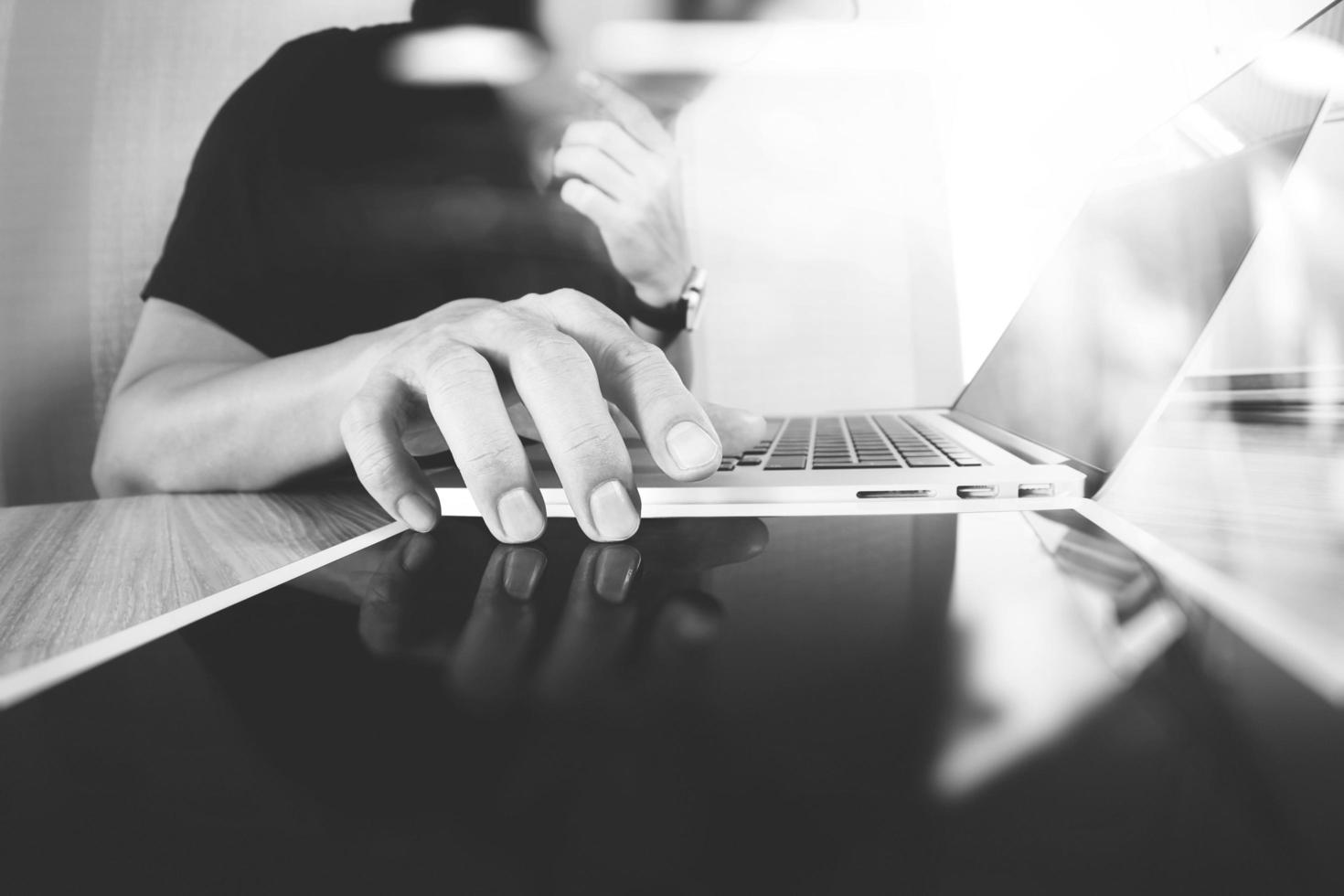 Website designer working digital tablet and computer laptop on wooden desk as concept photo