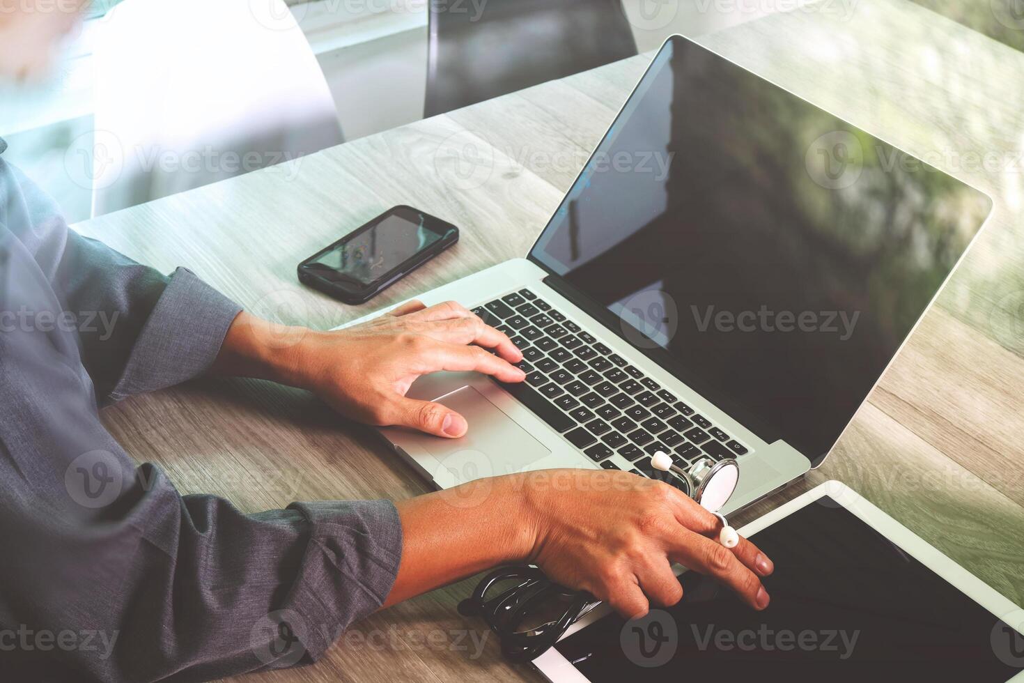 doctor hand working with modern digital tablet and laptop computer with computer interface as medical network concept photo