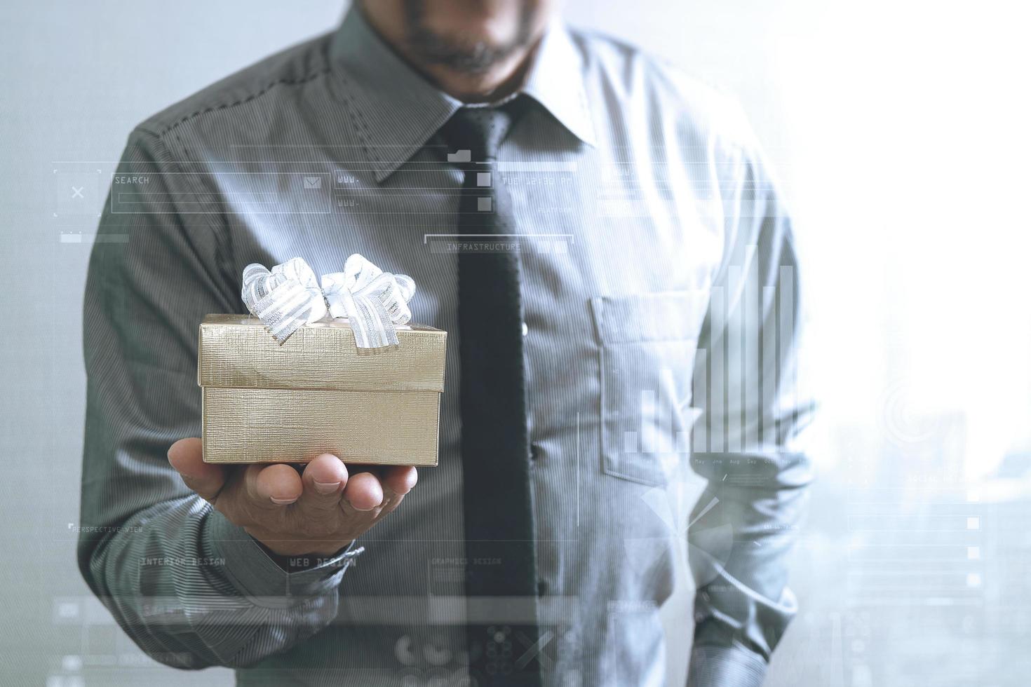 gift giving,businessman hand holding a gift box in a gesture of giving,front view,filter effect photo