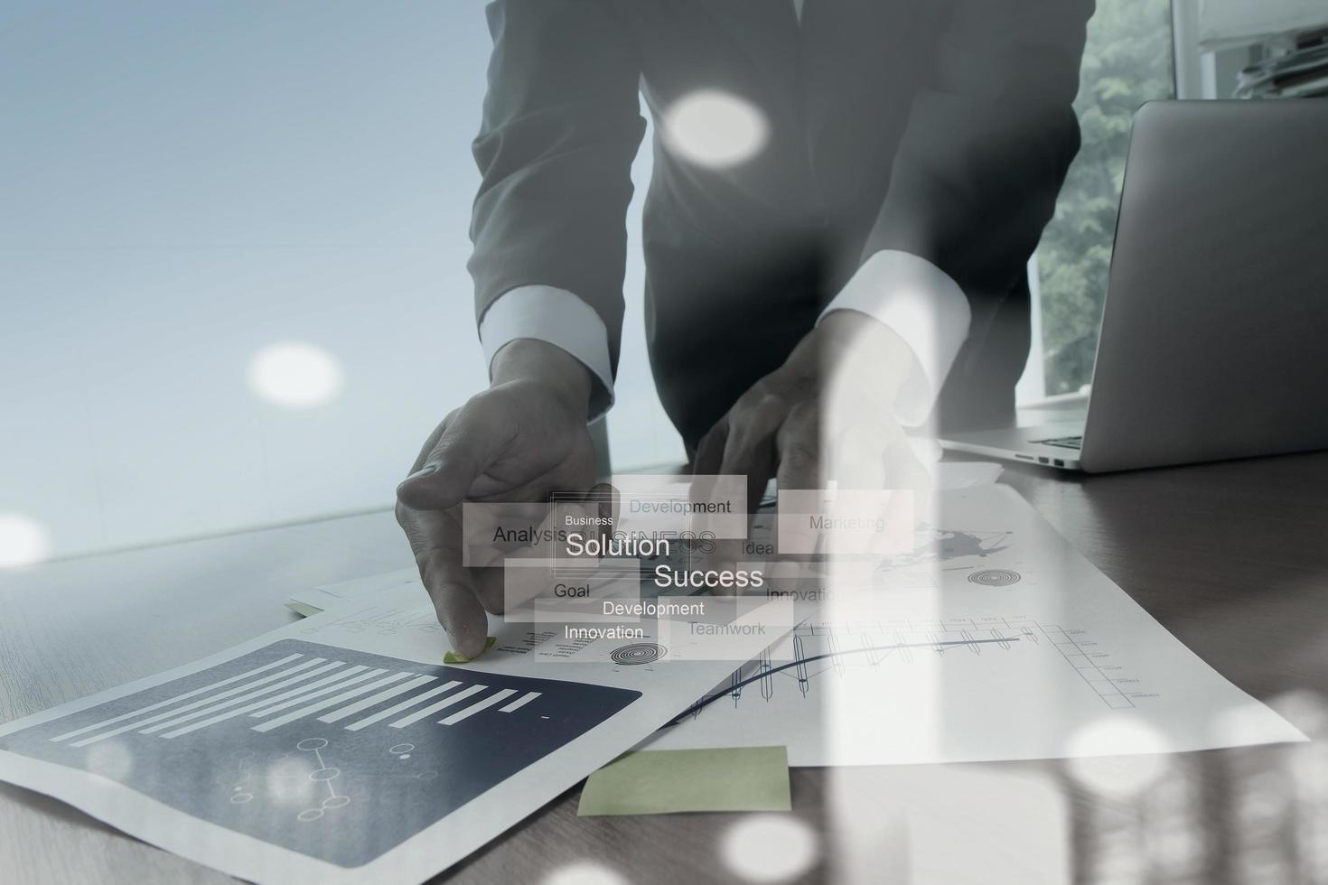 Double exposure of businessman hand working with new modern computer and business strategy as concept photo