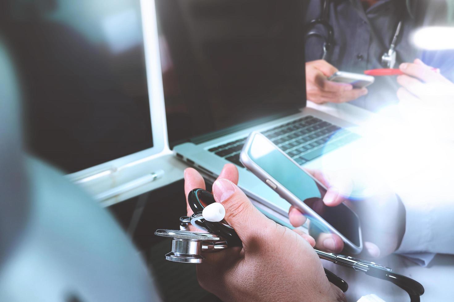 Medical technology network team meeting concept. Doctor hand working smart phone modern digital tablet laptop computer, sun flare effect photo