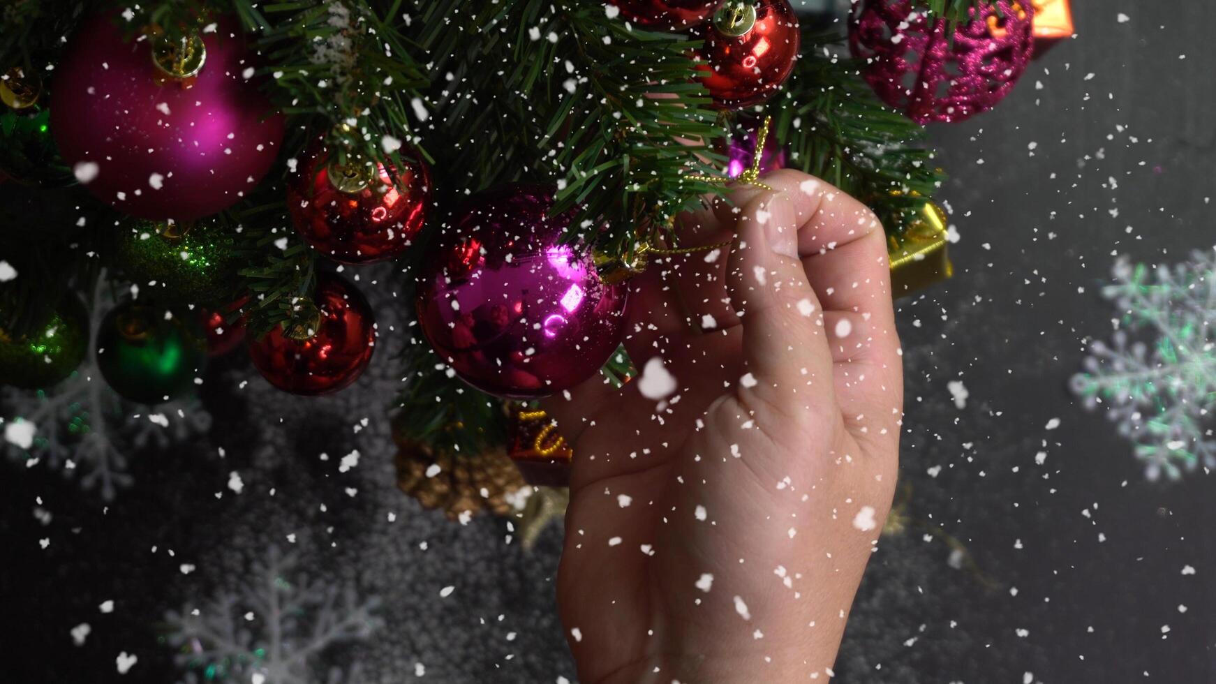 Greeting Season concept.hand setting of ornaments on a Christmas tree with decorative light photo