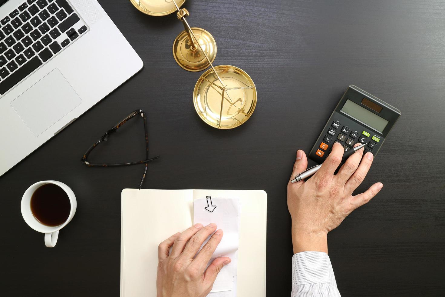 justice and law concept.businessman or lawyer or accountant working on accounts using a calculator and laptop computer and documents in modern office photo