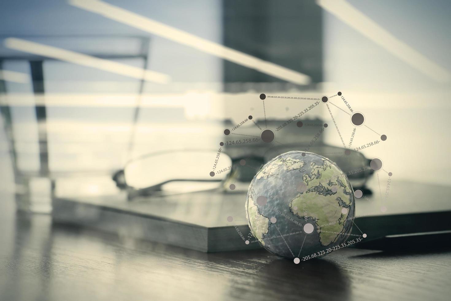 hand drawn texture globe with social media diagram on wood table near note book and glasses photo