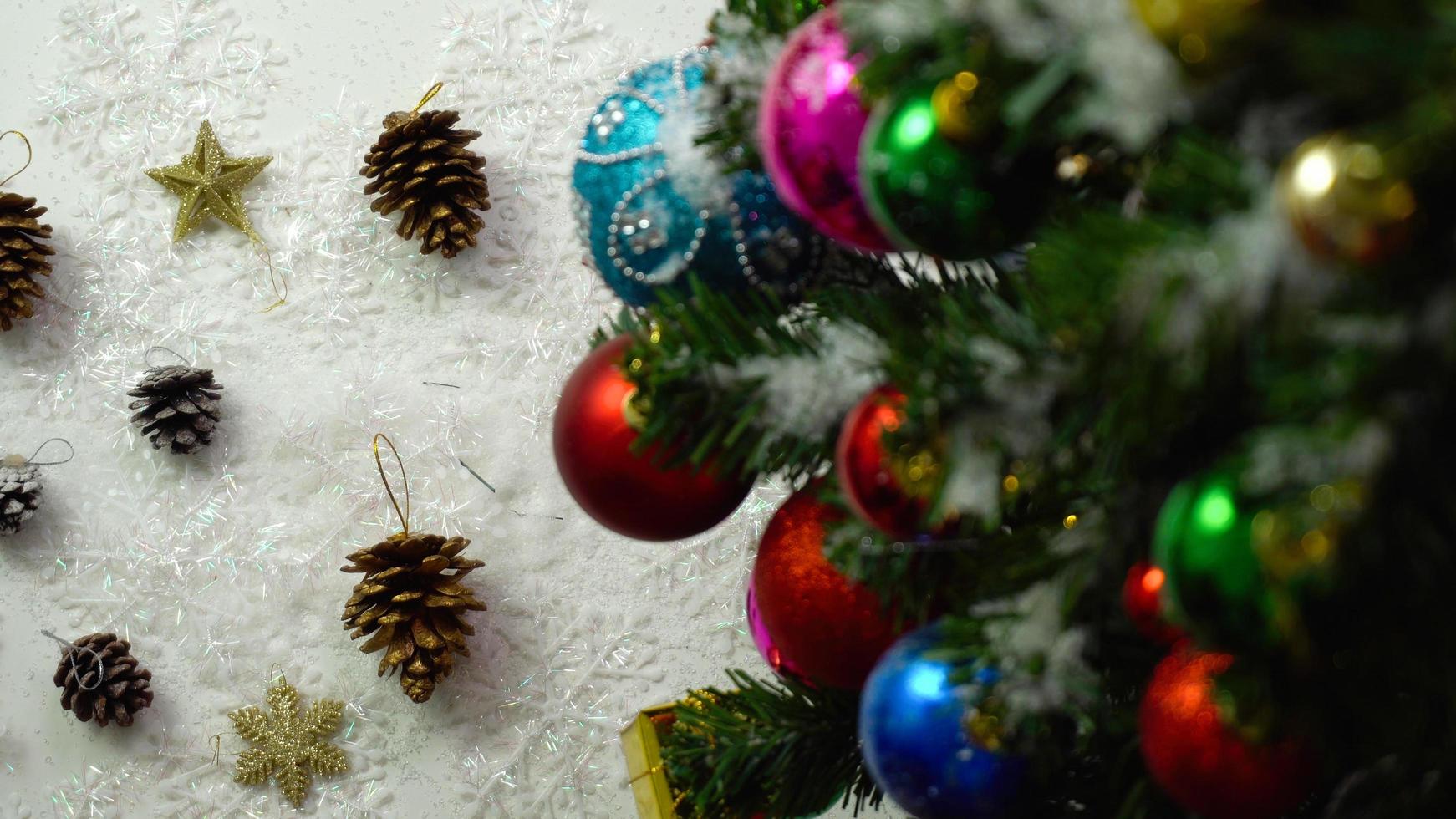 Greeting Season concept.hand setting of ornaments on a Christmas tree with decorative light photo