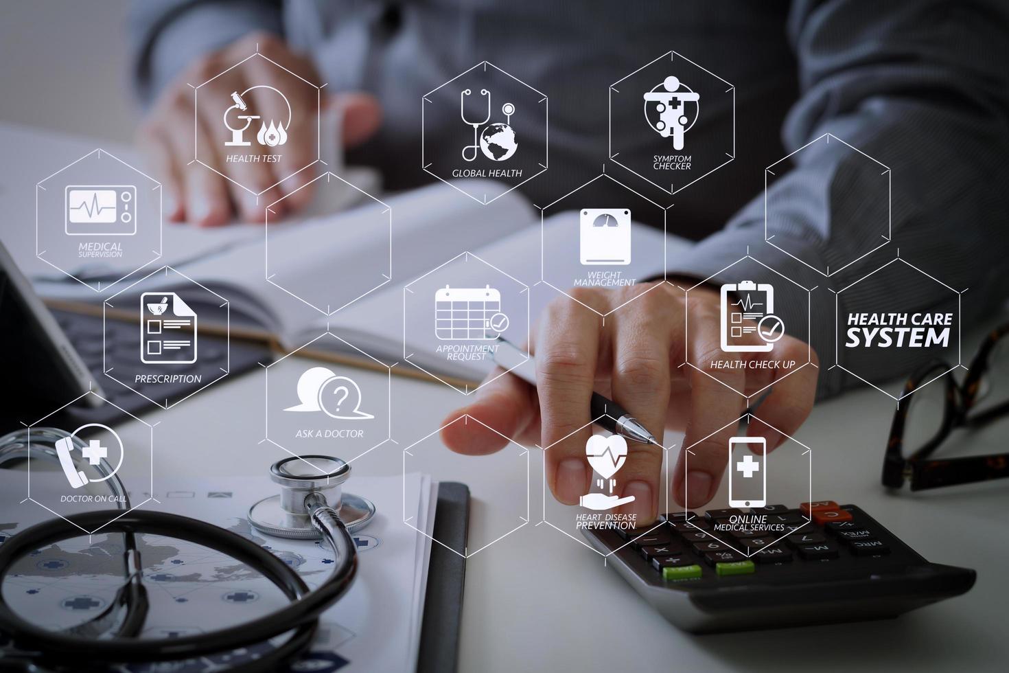 Healthcare costs and fees concept.Hand of smart doctor used a calculator for medical costs in modern hospital photo