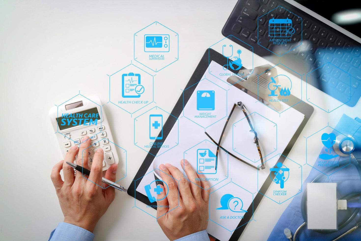 top view of Healthcare costs and fees concept.Hand of smart doctor used a calculator for medical costs in modern hospital photo