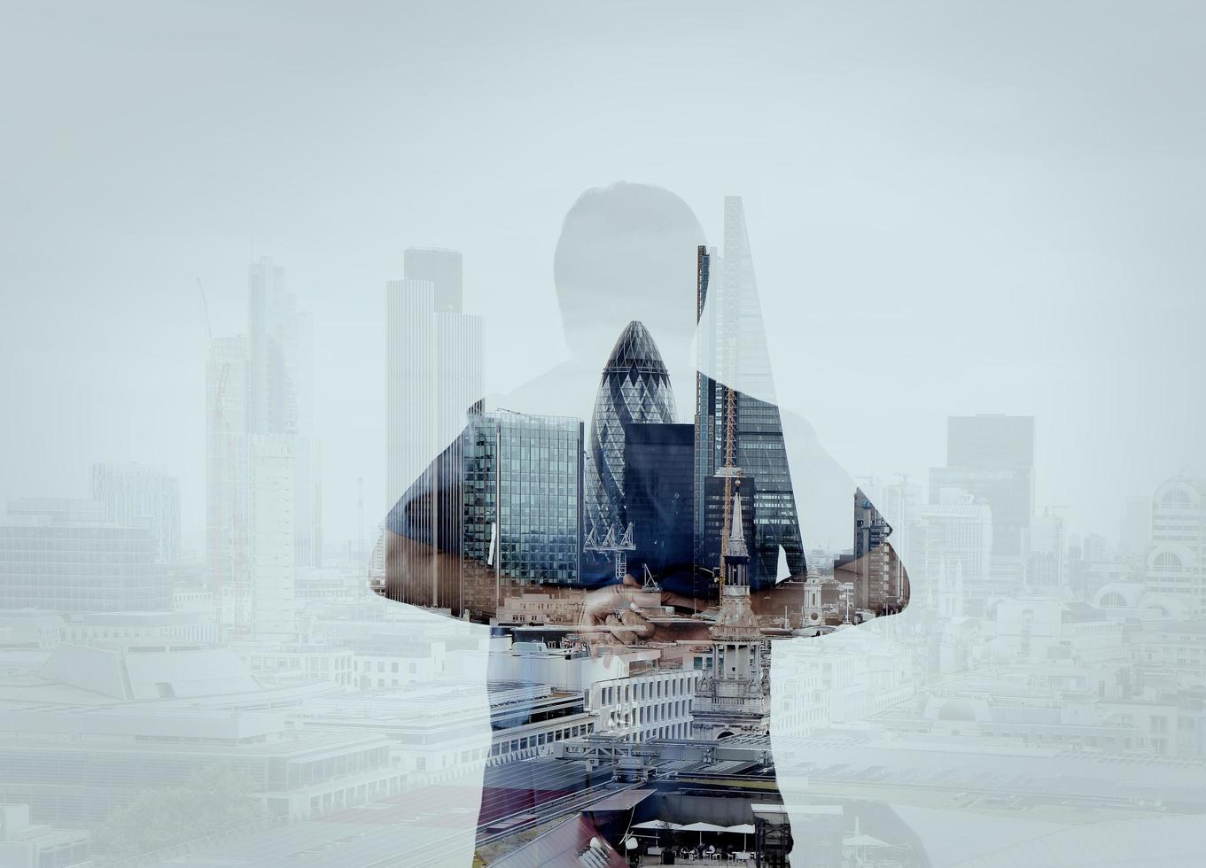 double exposure of smart medical doctor hand looking at london city as medical network and media concept photo