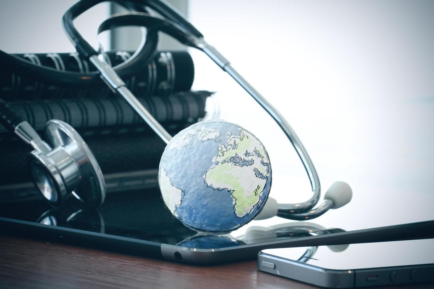 Studio macro of a stethoscope and texture globe with digital tablet with shallow DOF evenly matched abstract as medical network concept photo