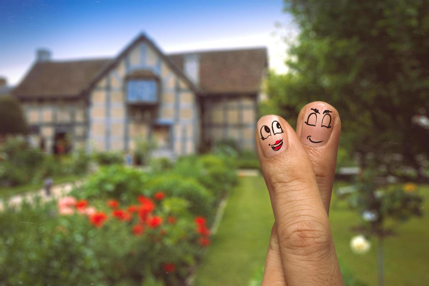 the happy finger couple in love with painted smiley on london house blurred background photo