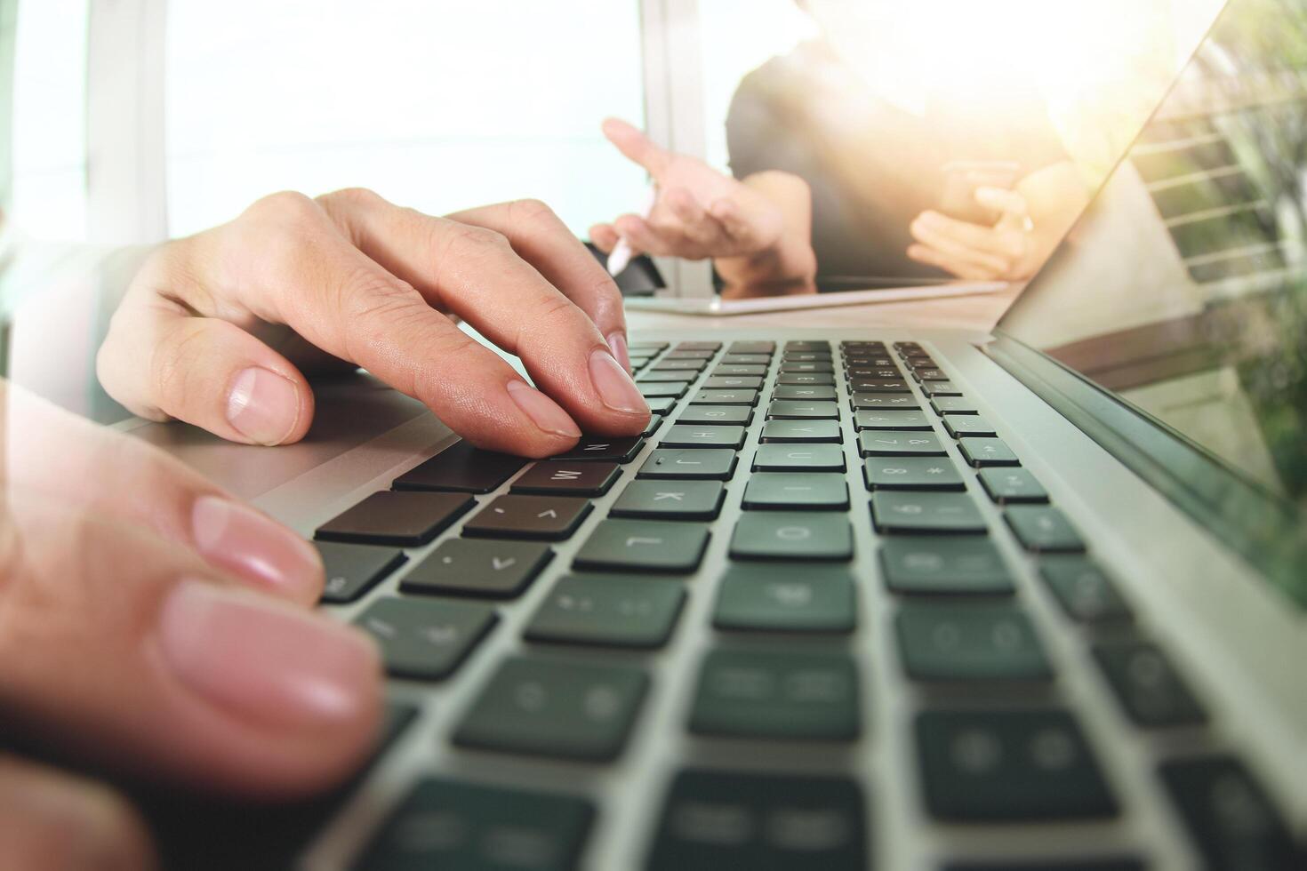 two colleagues Website designer working digital tablet and computer laptop with smart phone and digital design diagram on wooden desk as concept photo