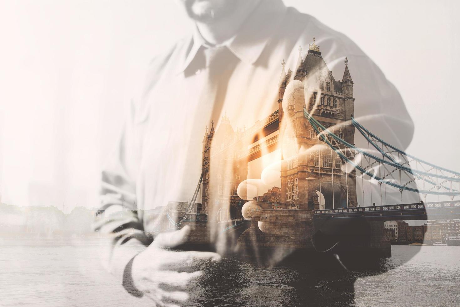 Double exposure of success businessman open his hand with London bridge, building,city,river,front view,filter effect photo