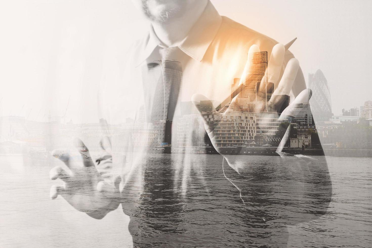 Double exposure of success businessman open his hand with London building,front view,filter effect photo
