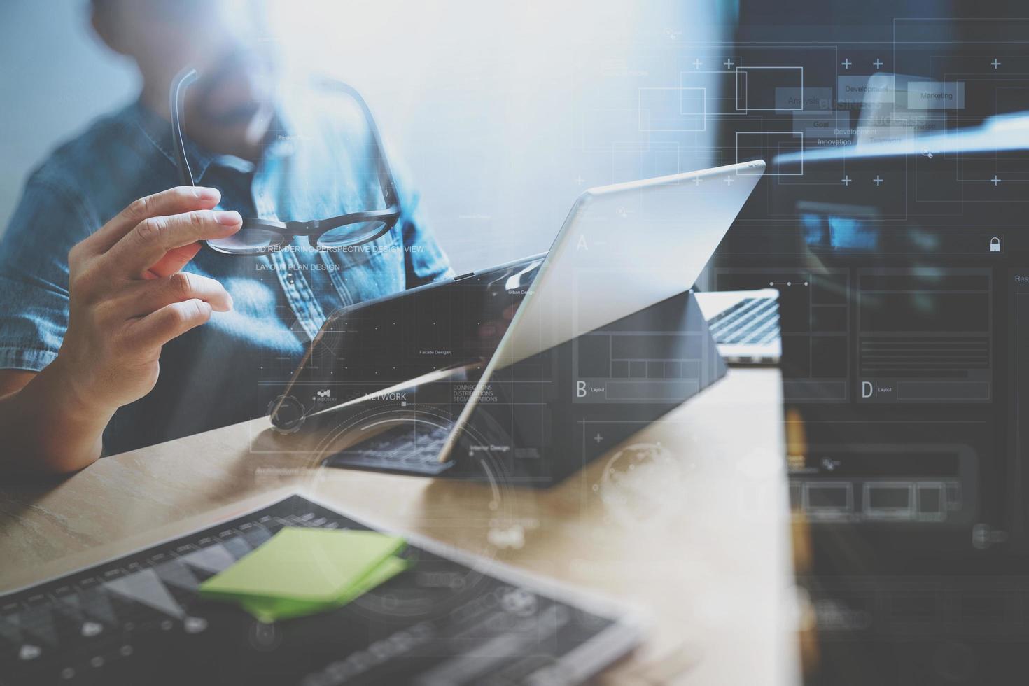 Website designer working digital tablet and computer laptop with digital tablet and digital design diagram on wooden desk and compact server photo