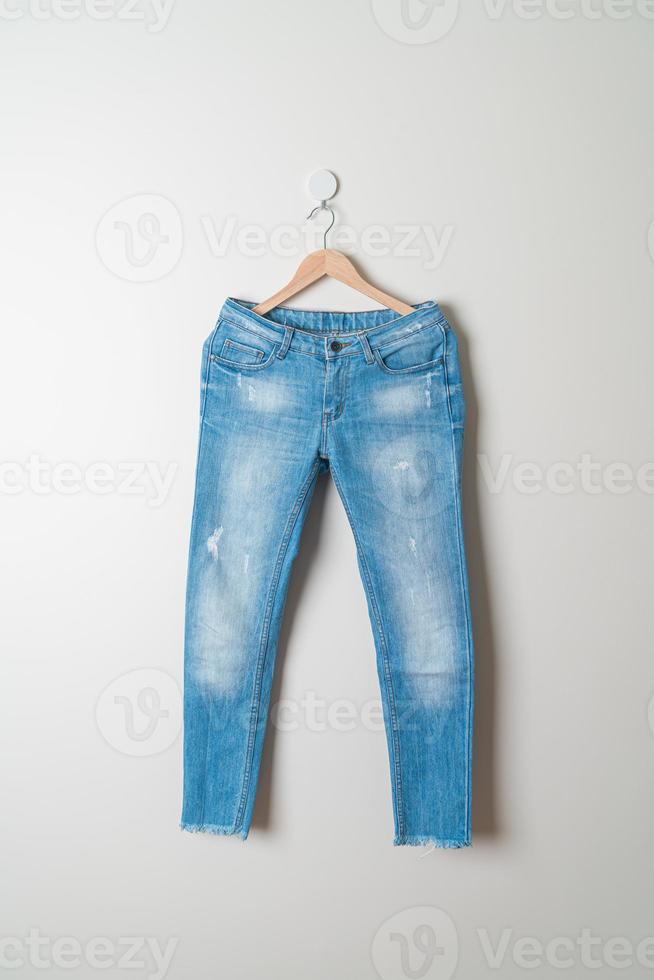 jeans trousers hanging on wall photo