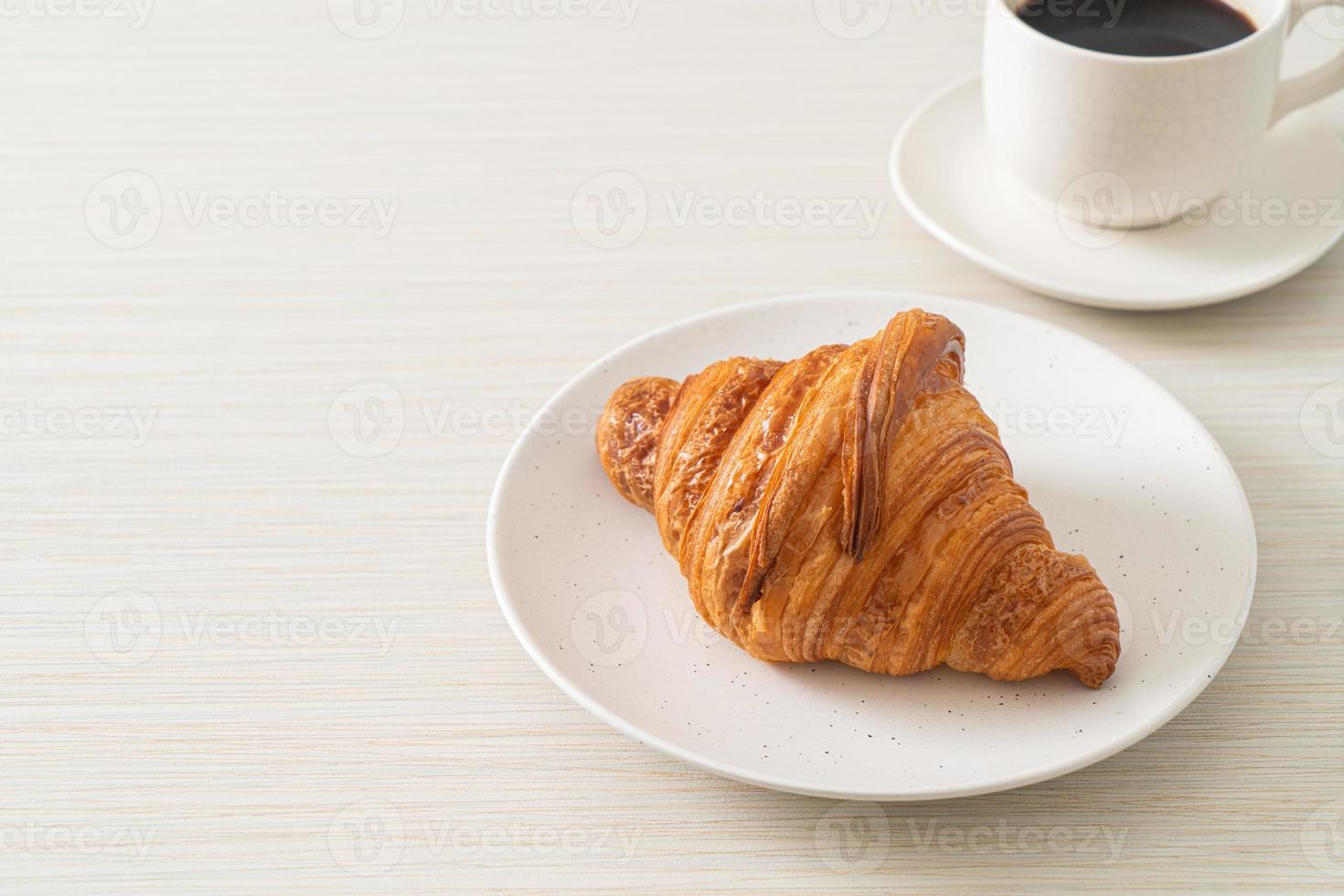 fresh croissant on white plate photo