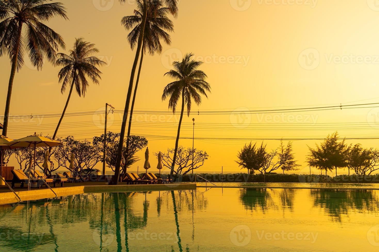 umbrella with bed pool around swimming pool with ocean sea background