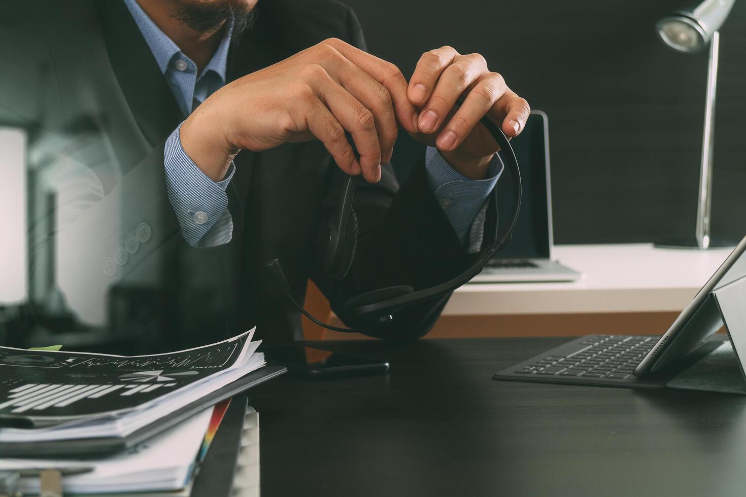 Man using VOIP headset with digital tablet computer as concept communication or it support or call center and customer service in modern office photo