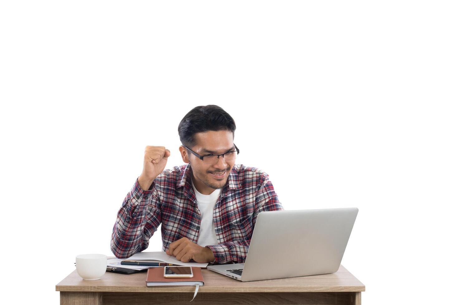 Young businessman working on laptop succeed with word at workplace isolated on white background. photo