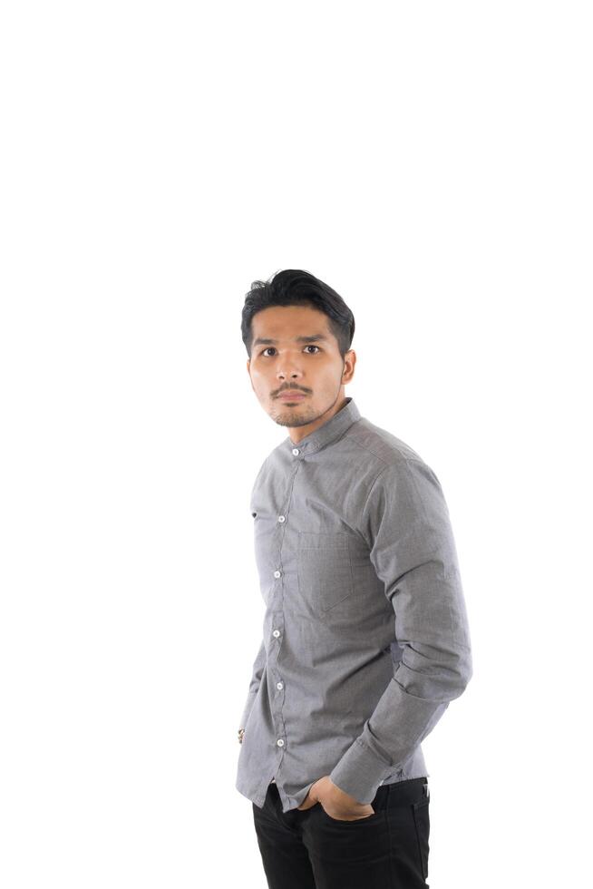 Handsome asian young hipster man standing at studio isolated on white background. photo