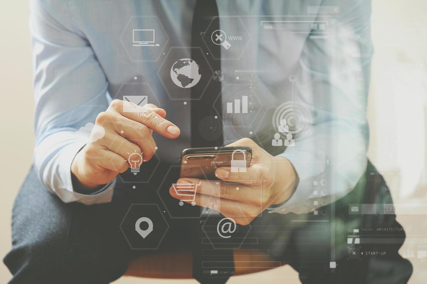 close up of businessman working with mobile phone and sitting on the chair in modern office photo