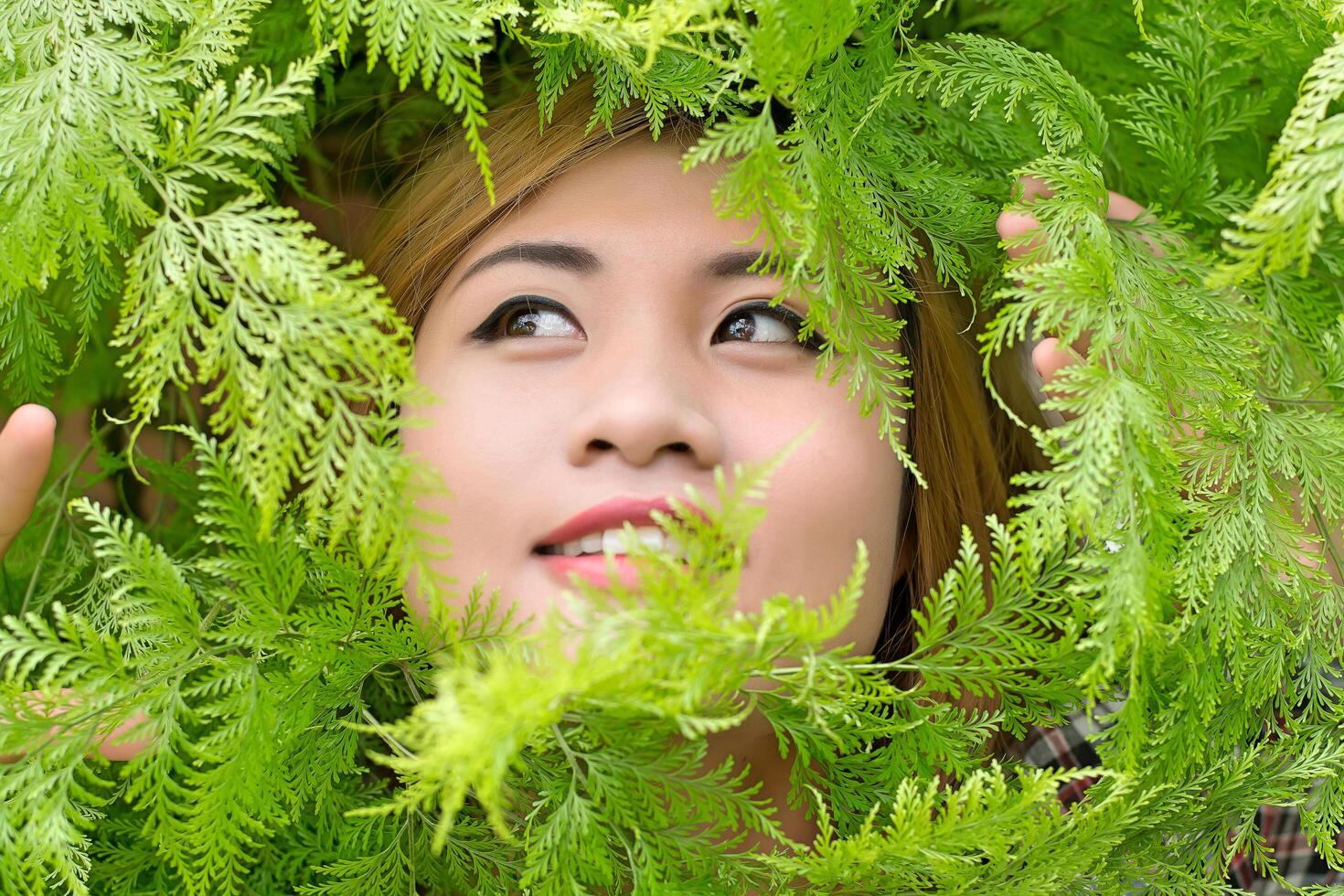 beautiful women in a grove of trees, ferns smiley. photo