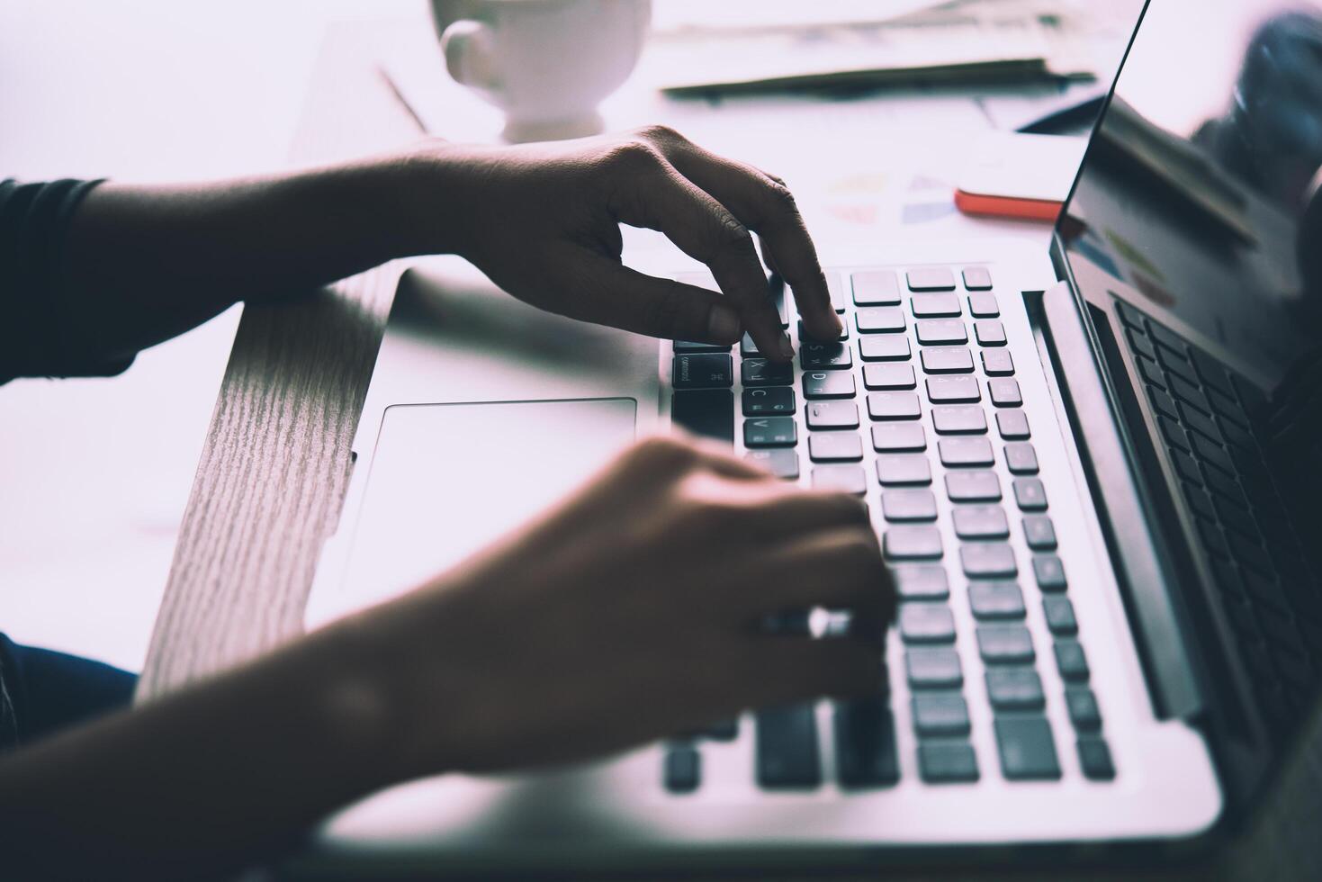 Close Up of a business woman hands typing on a laptop. photo