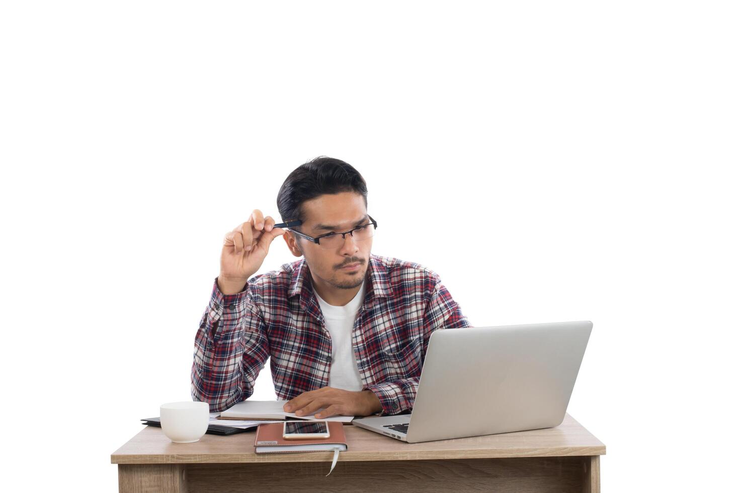 Young businessman working with his laptop isolated on white background. photo