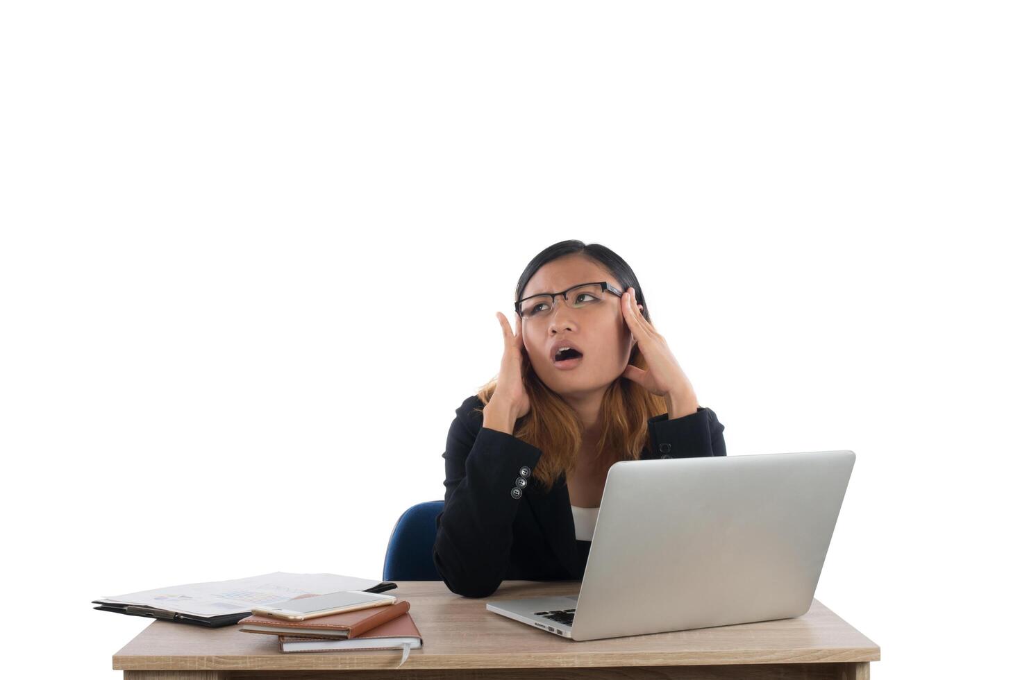 Stressed young business woman at the desk with a laptop isolated on white background. photo