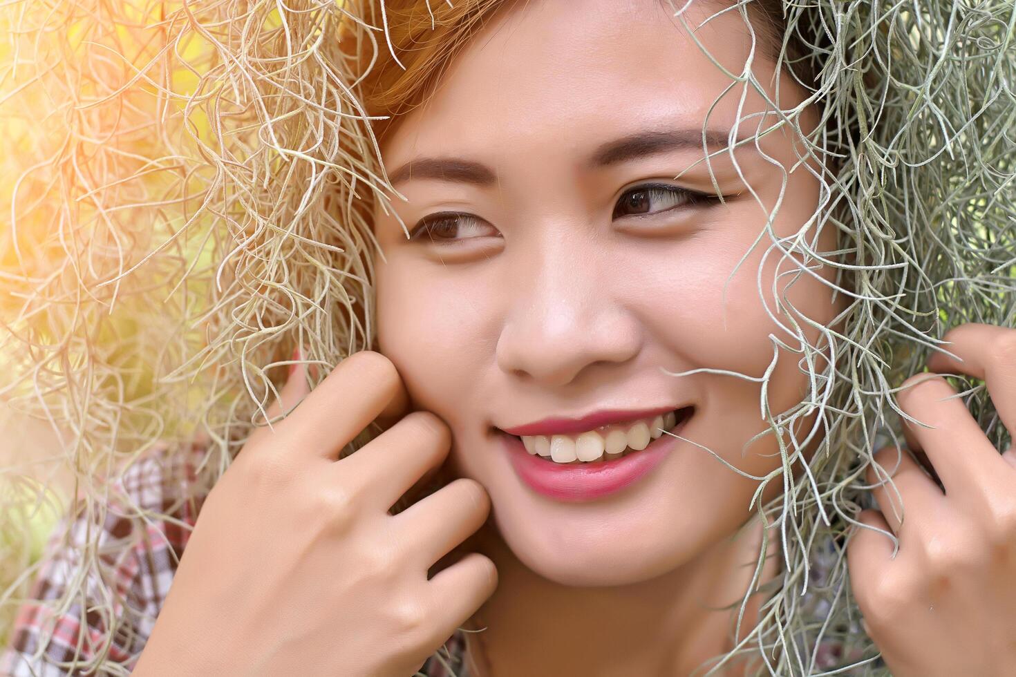 beautiful women in a grove of trees, ferns smiley. photo