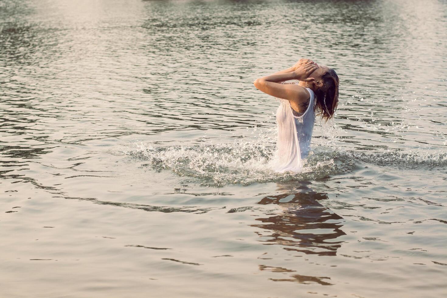 sad woman alone in the pond, sadness very Disappointed. photo