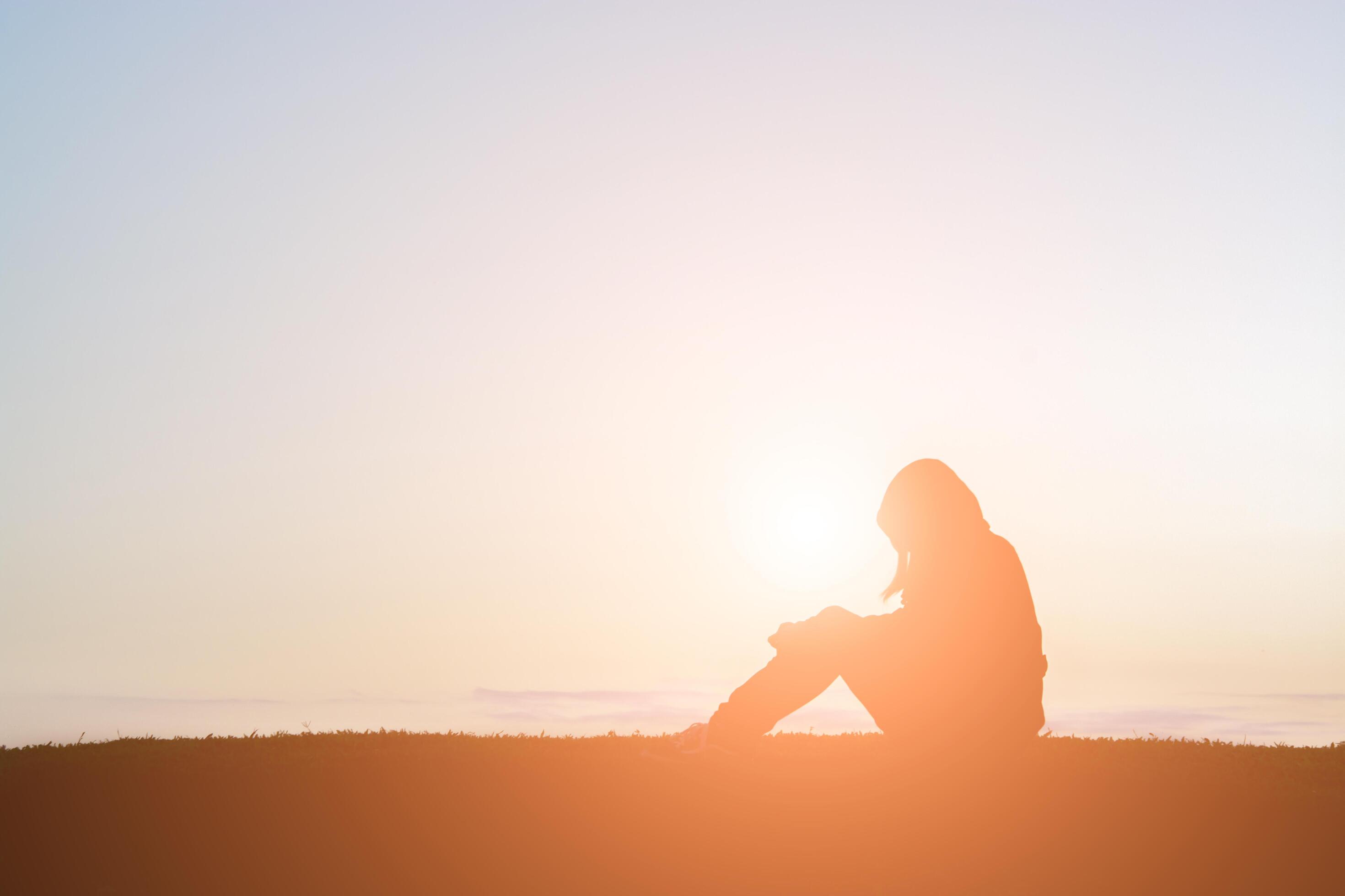 sad woman sitting silhouette