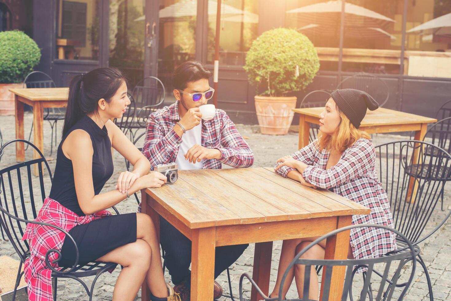 Group of young hipster sitting in a cafe,Young cheerful friends having fun while take time together, Holiday freedom enjoy. photo