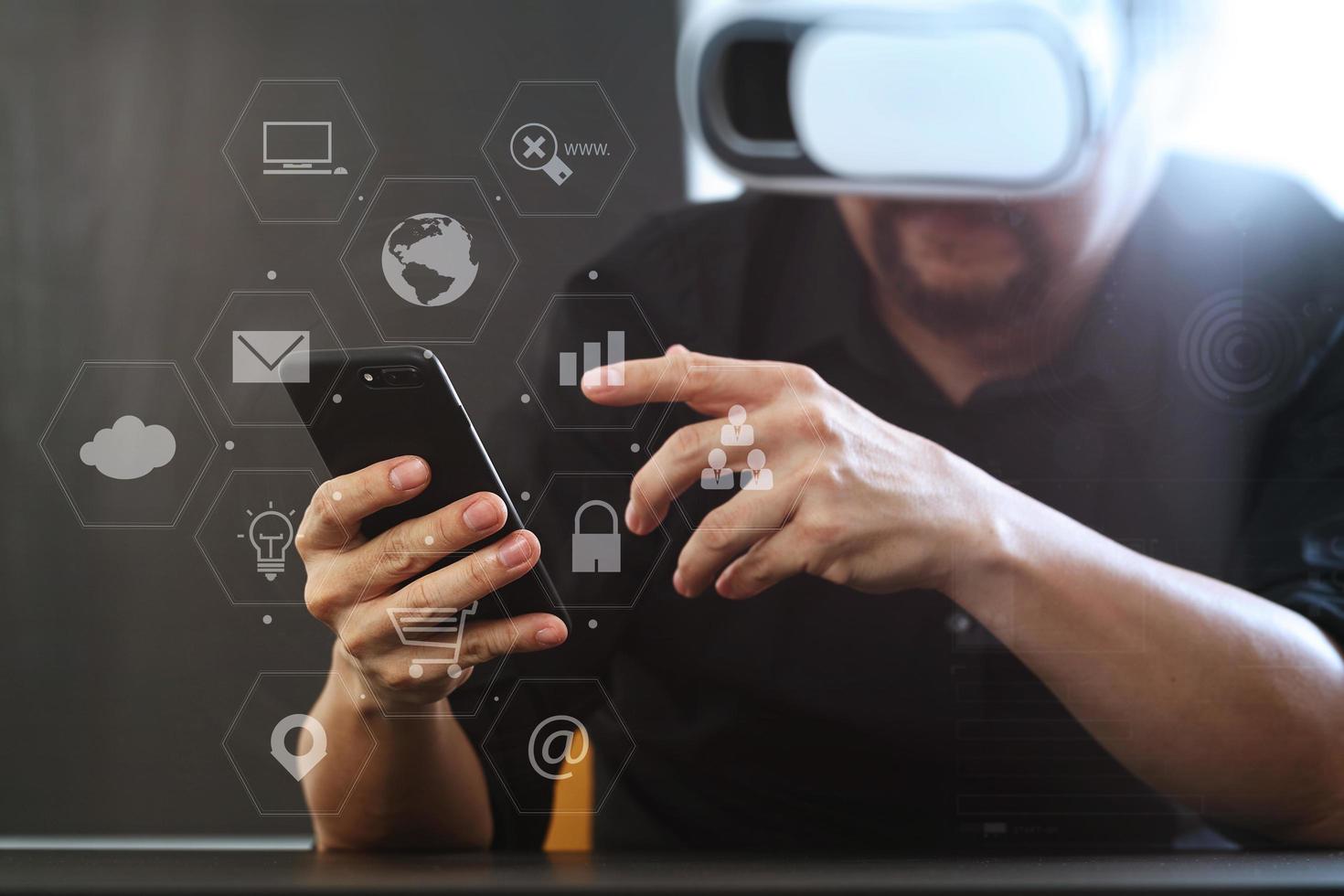 businessman wearing virtual reality goggles in modern office with mobile phone using with VR headset with screen icon diagram photo