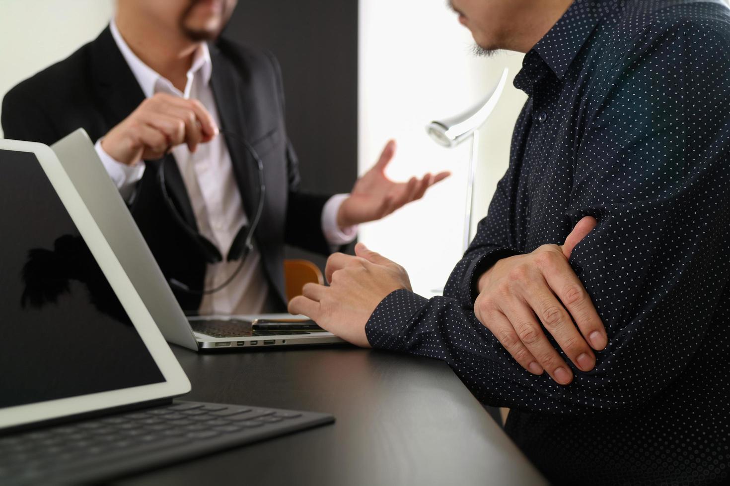 Co working team meeting concept,Man using VOIP headset with digital tablet and latop computer and smart phone in modern office photo