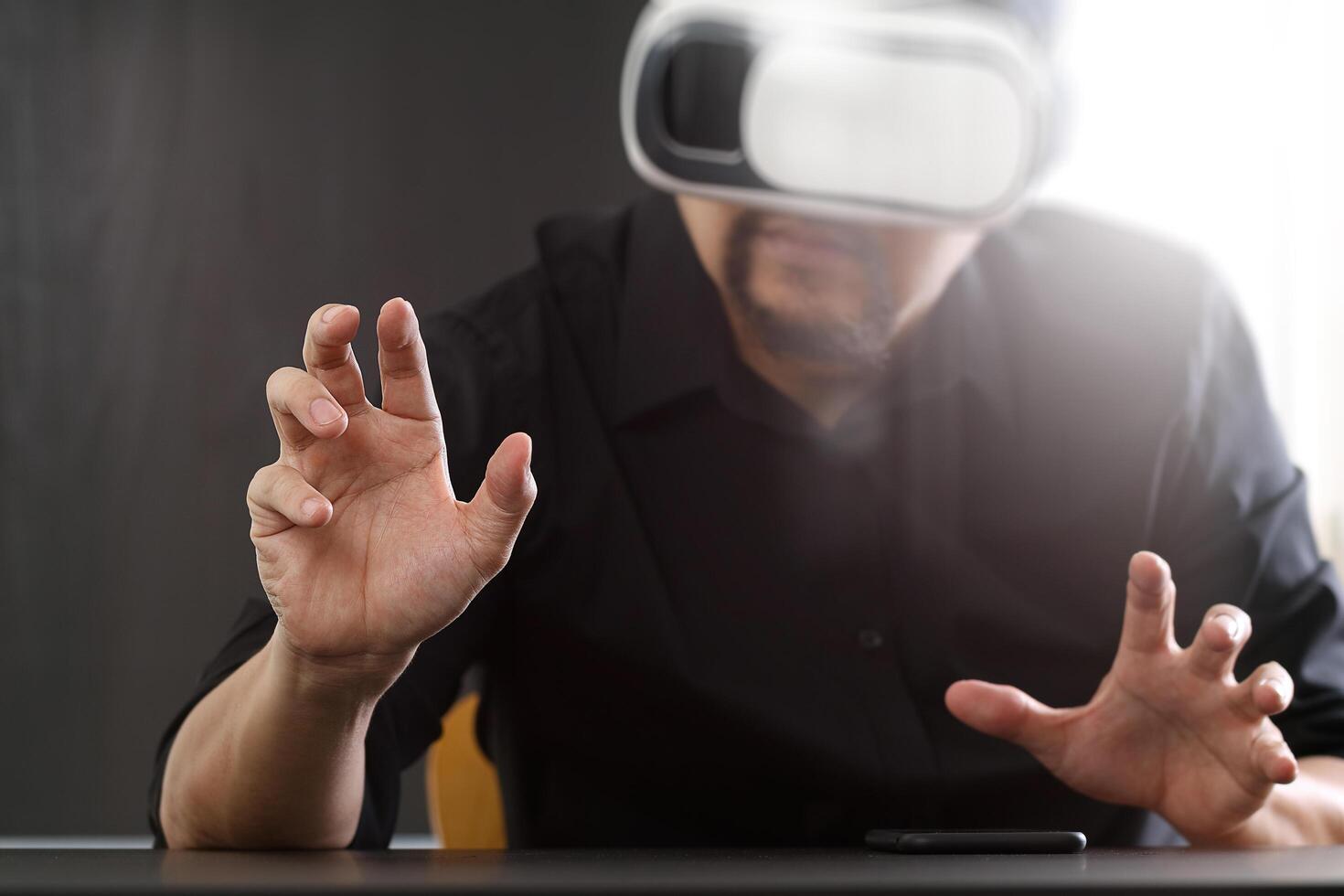 businessman wearing virtual reality goggles in modern office with