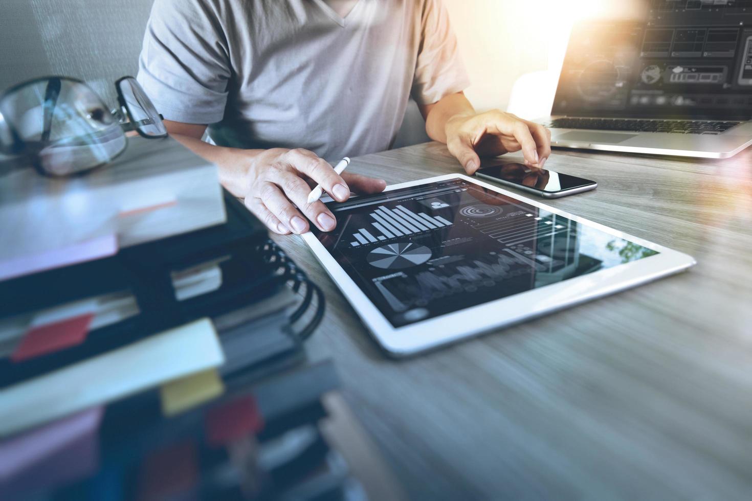 Website designer working digital tablet and computer laptop with smart phone and digital design diagram on wooden desk as concept photo