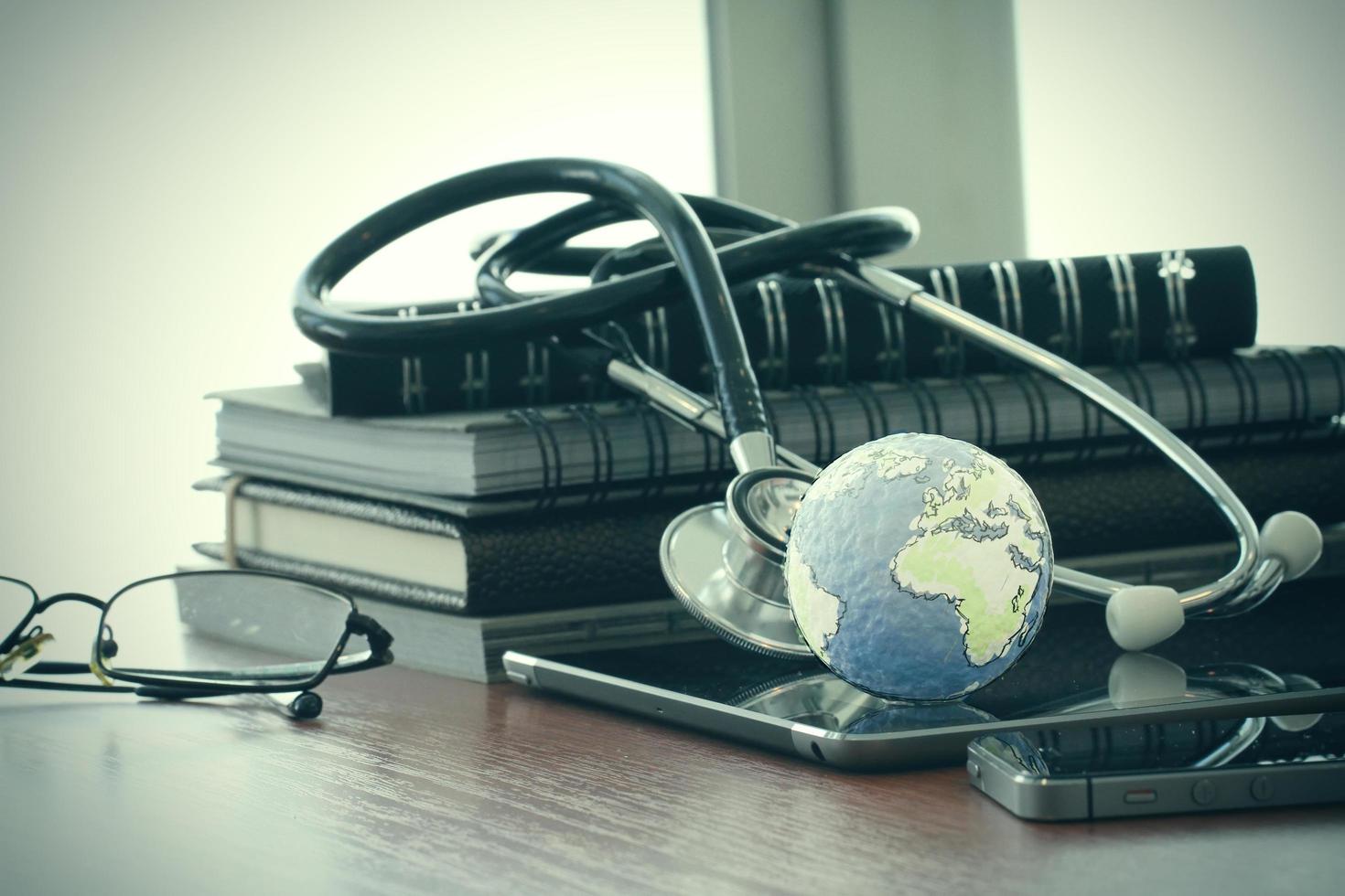 Studio macro of a stethoscope and texture globe with digital tablet with shallow DOF evenly matched abstract as medical network concept photo