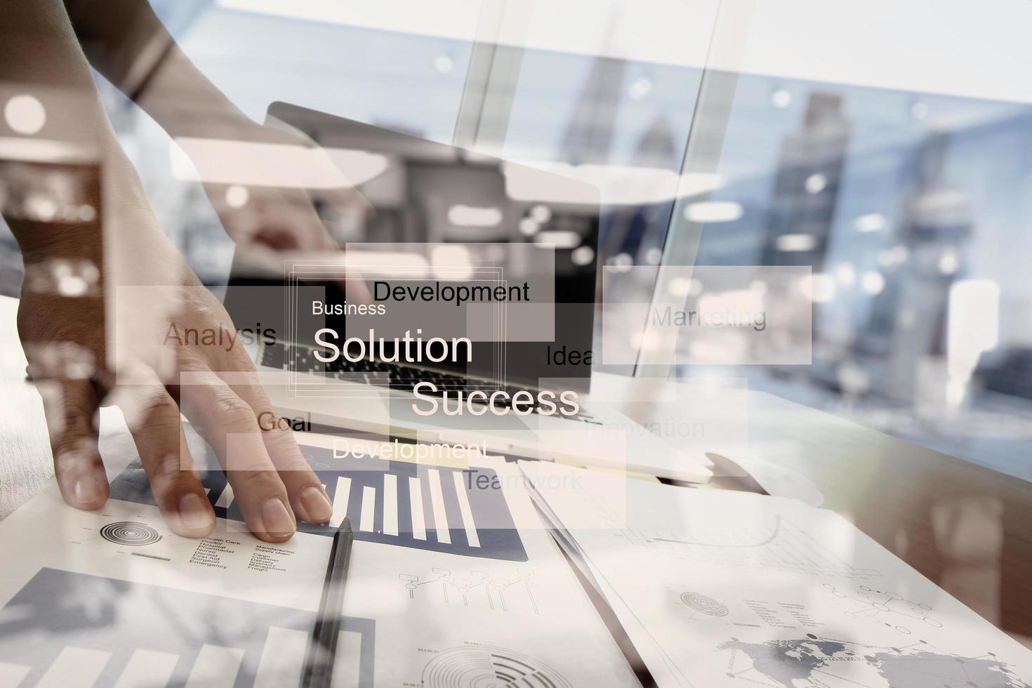 Double exposure of businessman hand working with new modern computer and business strategy as concept photo