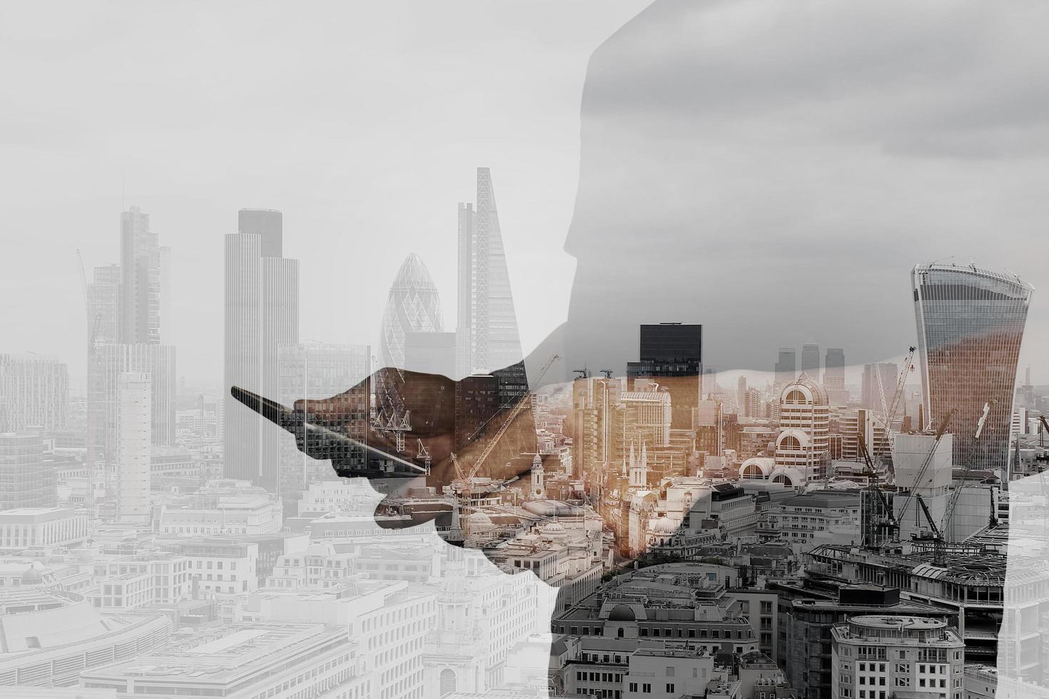 Double exposure of success businessman using digital tablet with london building and social media diagram photo