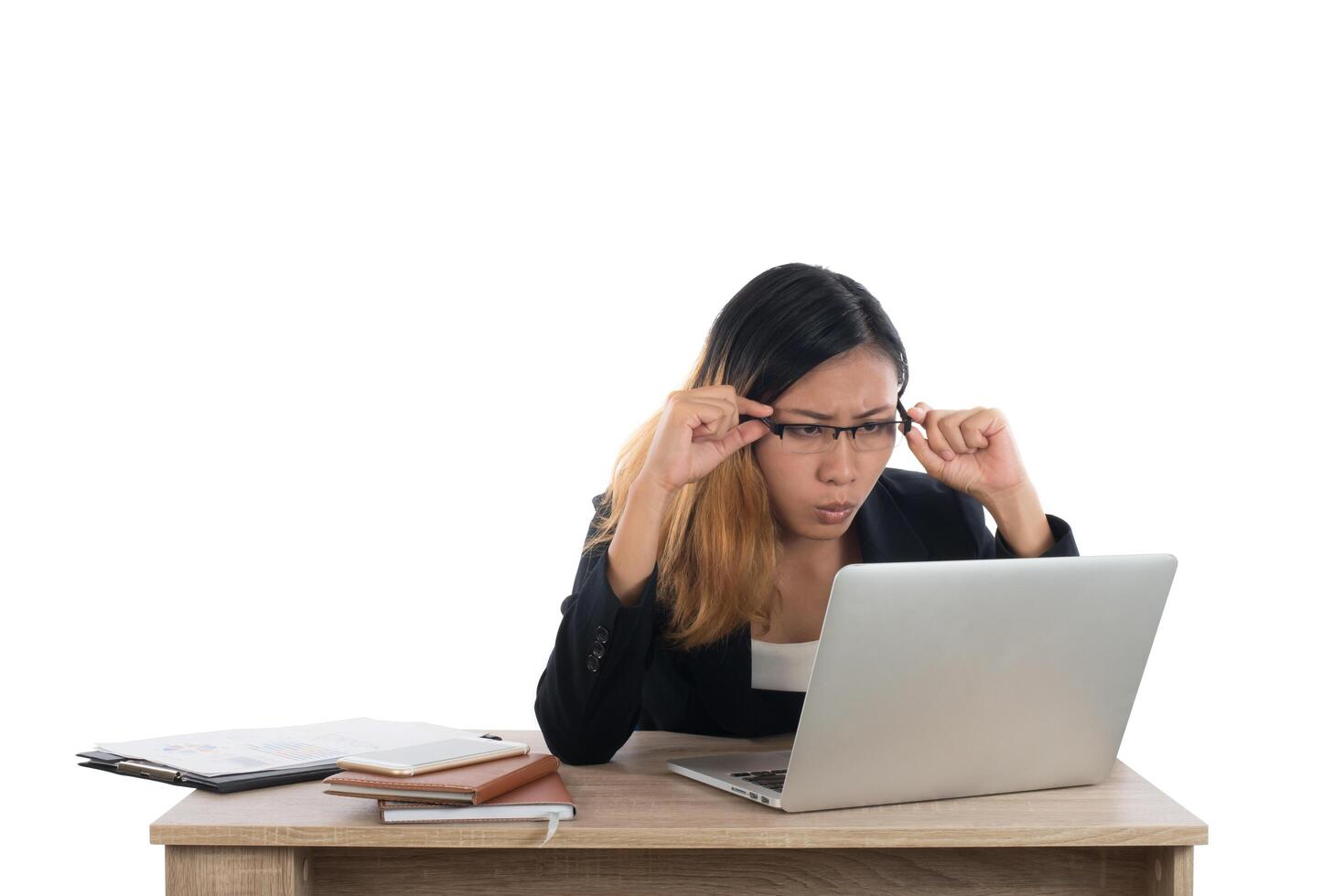 Stressed young business woman at the desk with a laptop isolated on white background. photo