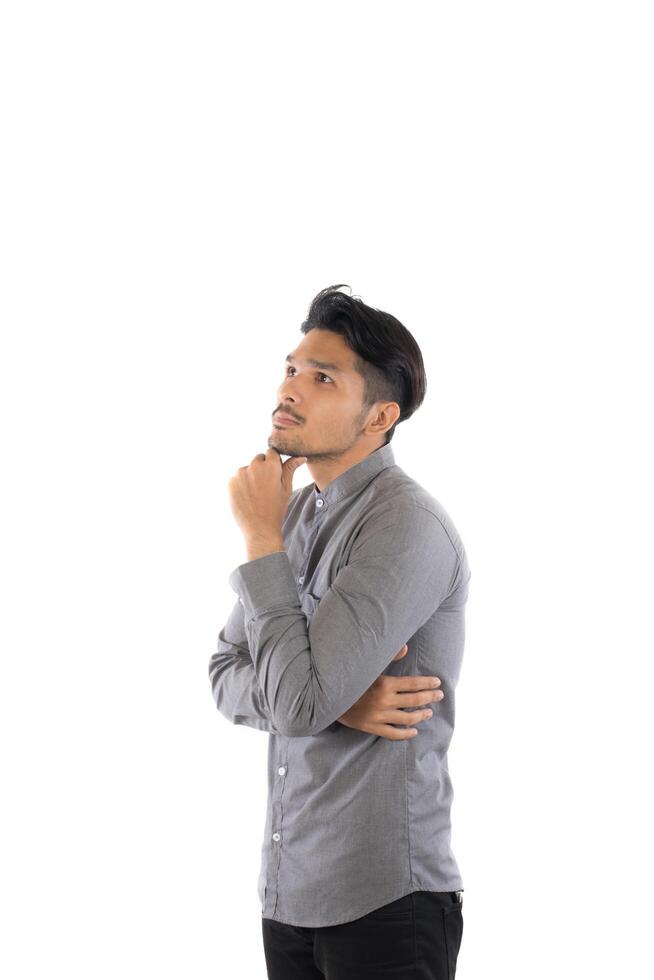 Handsome asian young hipster man standing at studio isolated on white background. photo