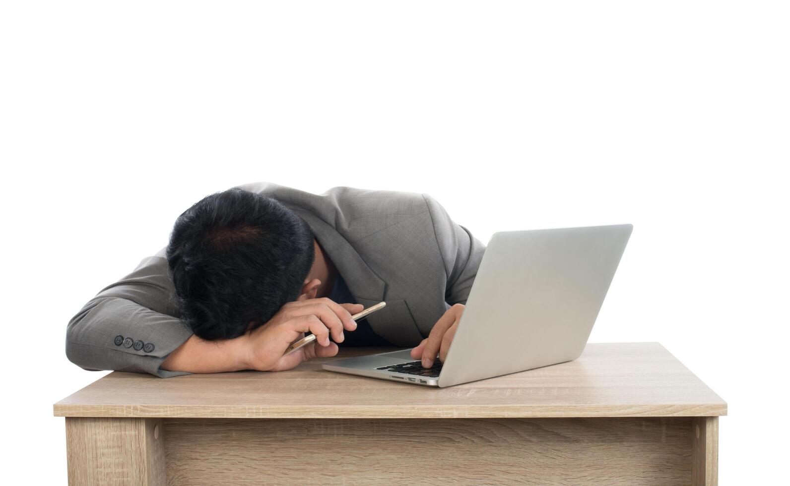 Businessman sleeping next to his laptop computer with white background. photo