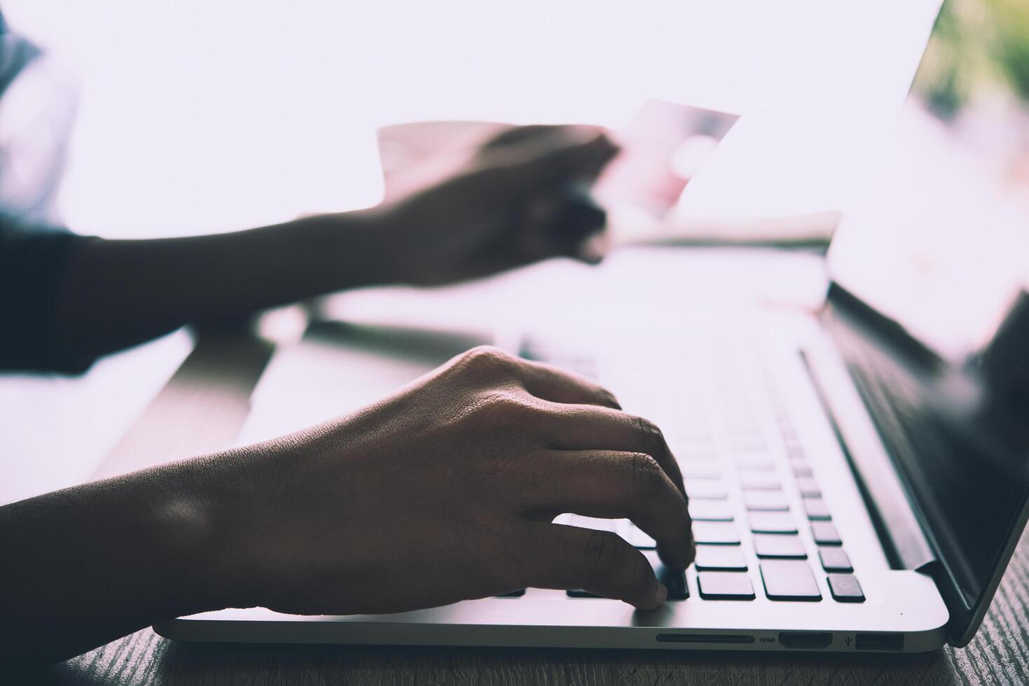 Woman hands holding credit card and using laptop. Online shopping. Freedom shopping. photo