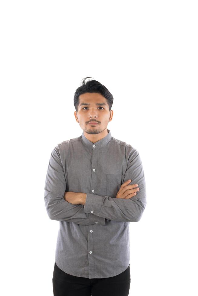Handsome asian young hipster man standing at studio isolated on white background. photo